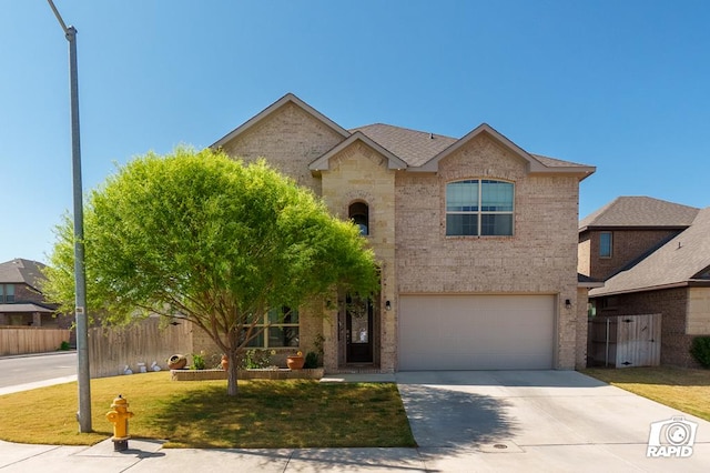 traditional-style home with a front lawn, fence, brick siding, an attached garage, and driveway