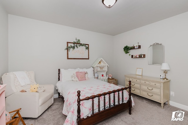 bedroom featuring baseboards and light carpet