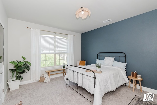 bedroom featuring baseboards, visible vents, and carpet