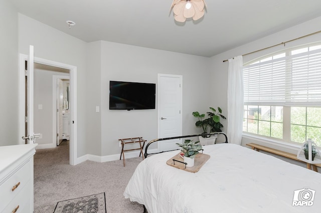 bedroom featuring baseboards and light carpet