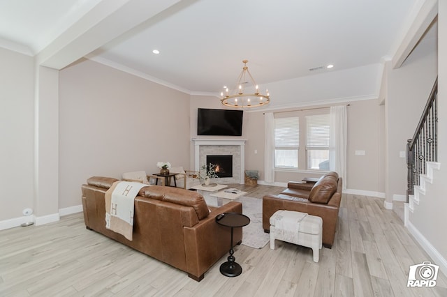 living room featuring light wood-type flooring, stairs, and an inviting chandelier