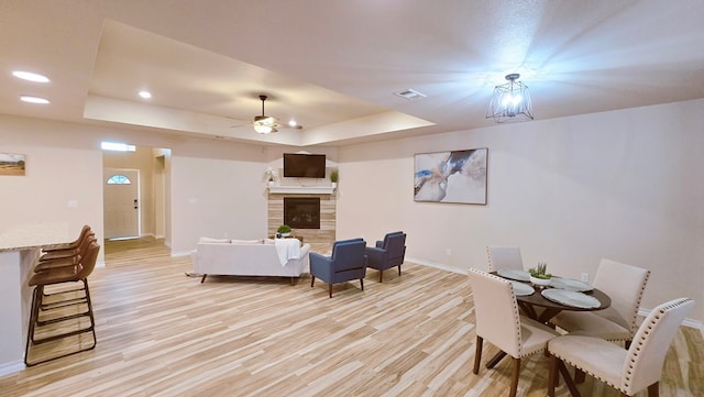 3630 El Cajon Ave, Odessa, TX 79765 - living room featuring a tray ceiling, baseboards, light wood-style flooring, ceiling fan, and recessed lighting