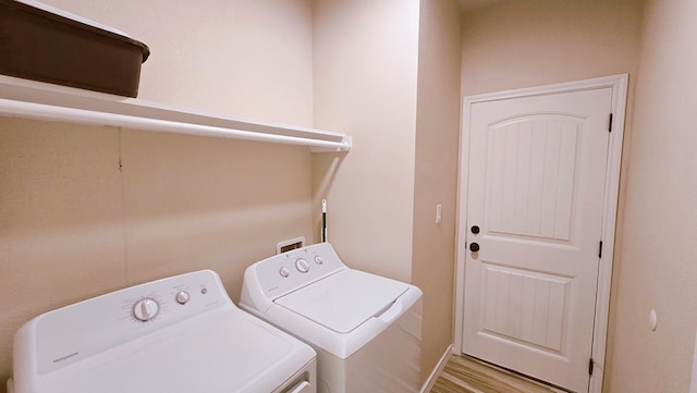 3630 El Cajon Ave, Odessa, TX 79765 - washroom featuring washer and clothes dryer and wood finished floors