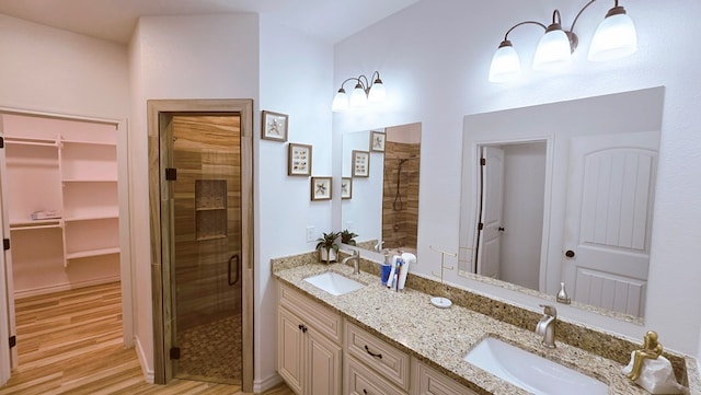 3630 El Cajon Ave, Odessa, TX 79765 - full bath featuring a stall shower, wood finished floors, a spacious closet, and double vanity