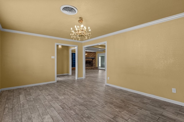 2900 E 21st St, Odessa, TX 79761 - unfurnished room with ornamental molding, wood finished floors, a chandelier, and baseboards