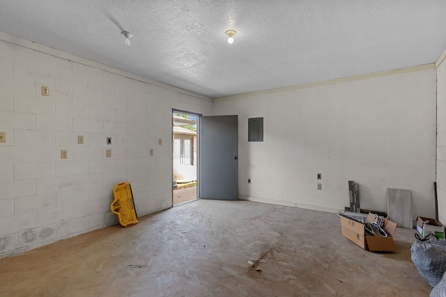 2900 E 21st St, Odessa, TX 79761 - unfurnished room featuring concrete flooring, electric panel, a textured ceiling, and concrete block wall