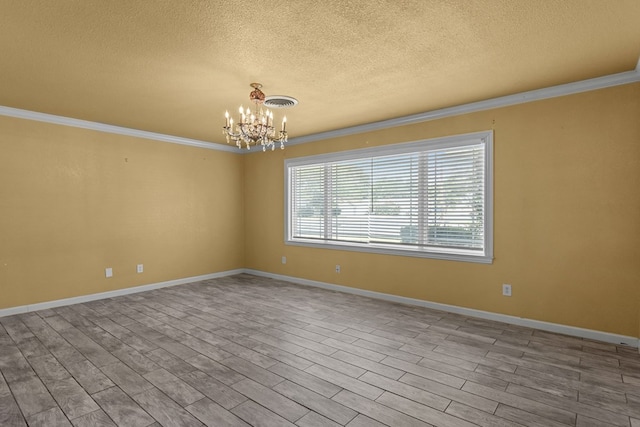2900 E 21st St, Odessa, TX 79761 - unfurnished room with crown molding, a textured ceiling, a chandelier, wood finished floors, and baseboards