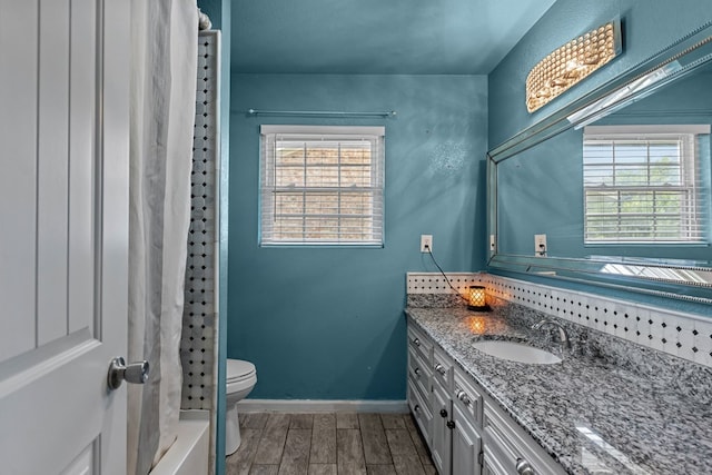 2900 E 21st St, Odessa, TX 79761 - full bath with vanity, wood tiled floors, toilet, and baseboards