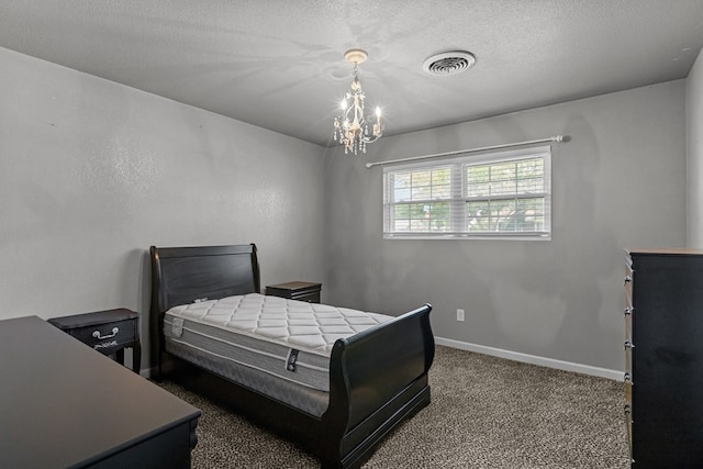 2900 E 21st St, Odessa, TX 79761 - carpeted bedroom featuring a chandelier, baseboards, and a textured ceiling