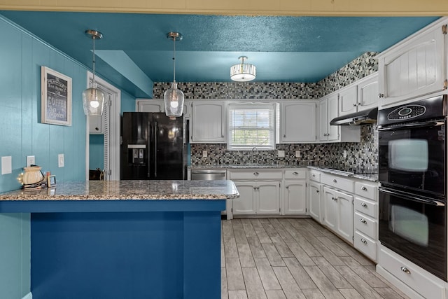 2900 E 21st St, Odessa, TX 79761 - kitchen featuring black appliances, a peninsula, white cabinetry, and backsplash