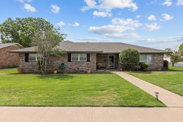 2900 E 21st St, Odessa, TX 79761 - ranch-style home featuring a front lawn, brick siding, and roof with shingles