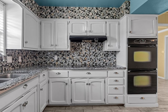 2900 E 21st St, Odessa, TX 79761 - kitchen featuring black appliances, a sink, under cabinet range hood, decorative backsplash, and light stone countertops