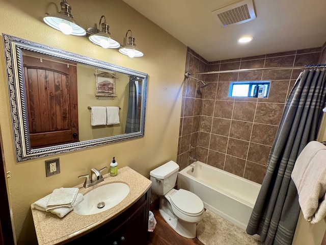 full bathroom with vanity, shower / bath combination with curtain, and toilet