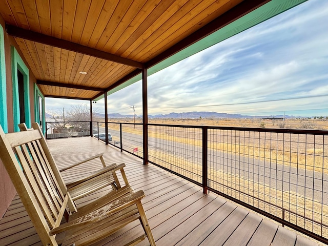 wooden deck featuring a mountain view