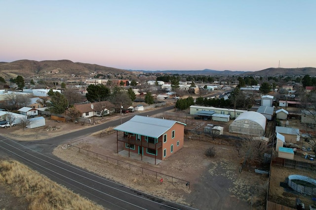 aerial view at dusk featuring a mountain view