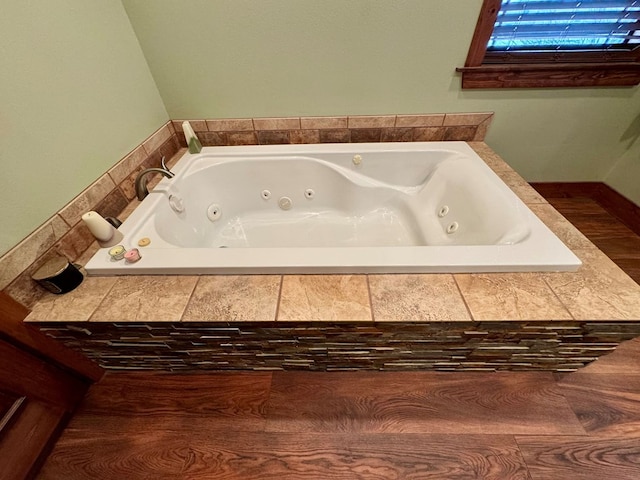 bathroom featuring a relaxing tiled tub