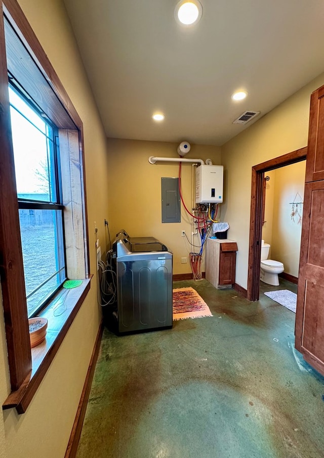 laundry room with washer / dryer, electric panel, and tankless water heater