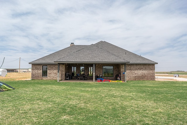 479 County Rd 306, Seminole, TX 79360 - back of house featuring a lawn, a patio area, and roof with shingles