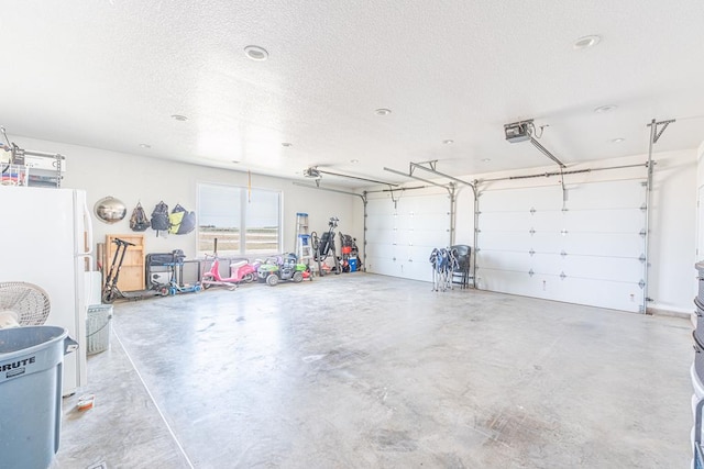 479 County Rd 306, Seminole, TX 79360 - garage featuring freestanding refrigerator and a garage door opener