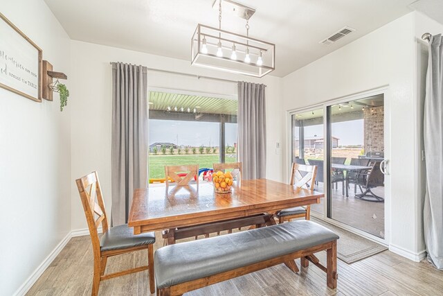 479 County Rd 306, Seminole, TX 79360 - dining room with baseboards, light wood-style flooring, and visible vents