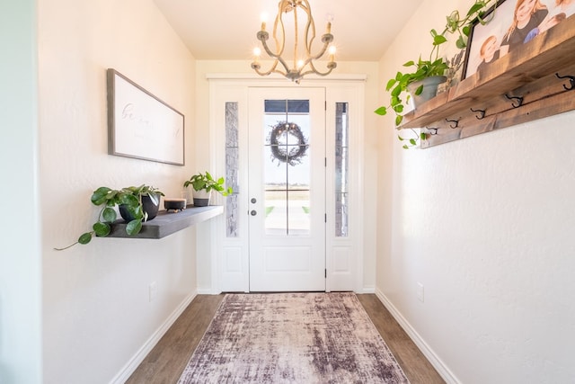 479 County Rd 306, Seminole, TX 79360 - entryway featuring baseboards, an inviting chandelier, and wood finished floors
