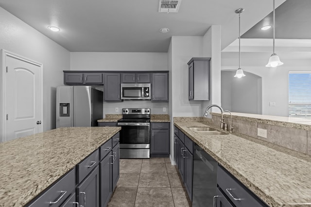 2208 Boise Dr, Odessa, TX 79762 - kitchen featuring appliances with stainless steel finishes, hanging light fixtures, light stone countertops, recessed lighting, and arched walkways