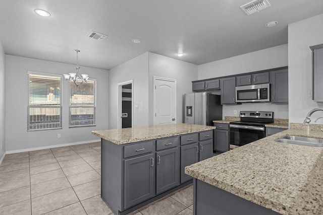 2208 Boise Dr, Odessa, TX 79762 - kitchen featuring stainless steel appliances, a chandelier, a kitchen island, pendant lighting, and gray cabinets