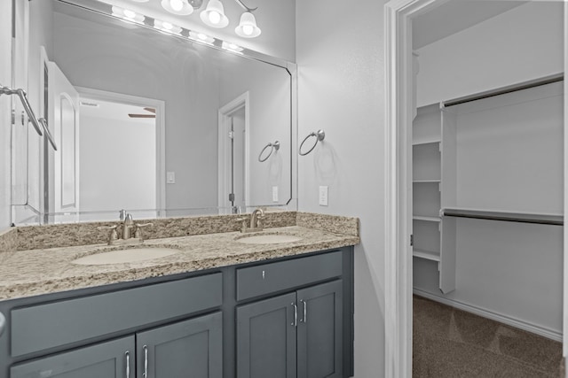 2208 Boise Dr, Odessa, TX 79762 - bathroom with double vanity and a spacious closet
