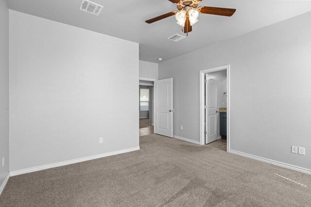 2208 Boise Dr, Odessa, TX 79762 - unfurnished bedroom featuring light colored carpet, a ceiling fan, and connected bathroom
