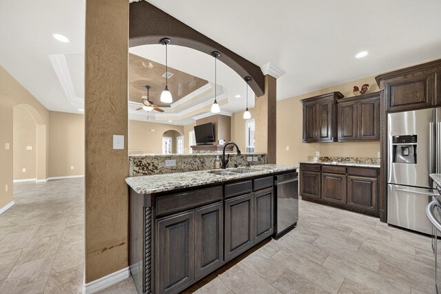 14 Da Vinci Ct, Odessa, TX 79765 - kitchen with stainless steel fridge with ice dispenser, a sink, dishwashing machine, ceiling fan, and dark brown cabinets