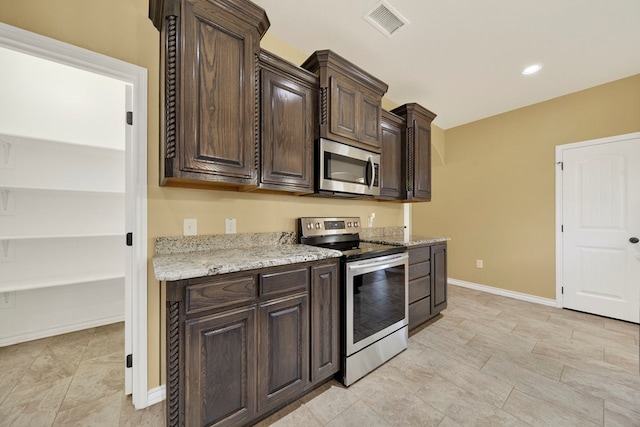 14 Da Vinci Ct, Odessa, TX 79765 - kitchen featuring stainless steel appliances, dark brown cabinets, baseboards, and light stone counters