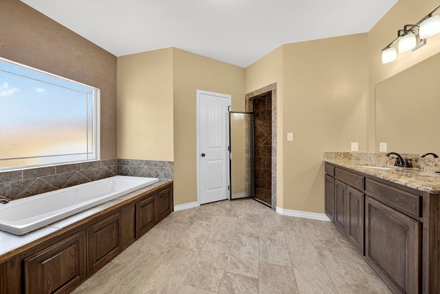 14 Da Vinci Ct, Odessa, TX 79765 - full bath featuring vanity, a shower stall, a garden tub, and baseboards