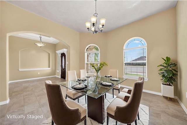 14 Da Vinci Ct, Odessa, TX 79765 - dining space featuring arched walkways, a chandelier, and baseboards