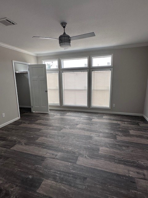 610 Magnolia, Kermit, TX 79745 - spare room with ornamental molding, dark wood-style floors, and a ceiling fan