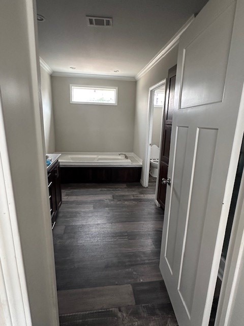 610 Magnolia, Kermit, TX 79745 - bathroom featuring ornamental molding, a garden tub, wood finished floors, and vanity
