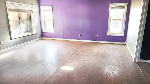 1000 N 12th St, Wink, TX 79789 - empty room with wood-type flooring, plenty of natural light, and baseboards