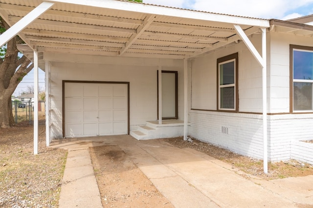 view of front of house featuring concrete driveway, fence, and a carport
