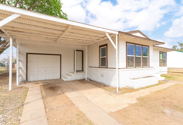single story home featuring concrete driveway, a garage, and a carport