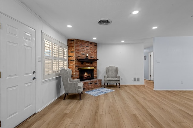 3700 Fairmont Dr, Odessa, TX 79762 - sitting room with light wood-style flooring, a brick fireplace, recessed lighting, and ornamental molding