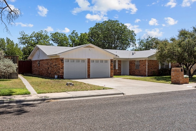 3700 Fairmont Dr, Odessa, TX 79762 - view of front facade with an attached garage, brick siding, and driveway