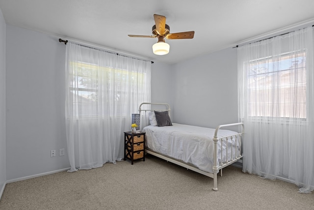 3700 Fairmont Dr, Odessa, TX 79762 - bedroom featuring multiple windows, carpet, and a ceiling fan