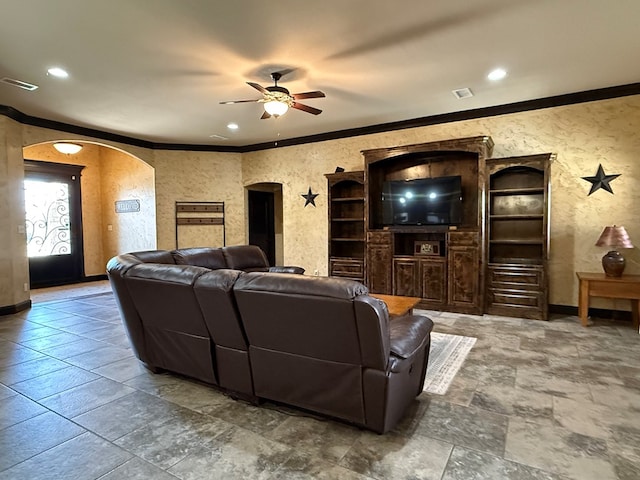 7802 Sienna Dr, Odessa, TX 79765 - living room with arched walkways, crown molding, a ceiling fan, stone tile floors, and recessed lighting