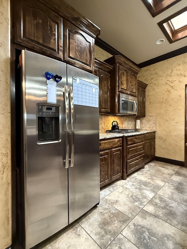 7802 Sienna Dr, Odessa, TX 79765 - kitchen featuring stainless steel appliances, dark brown cabinetry, backsplash, ornamental molding, and light stone countertops