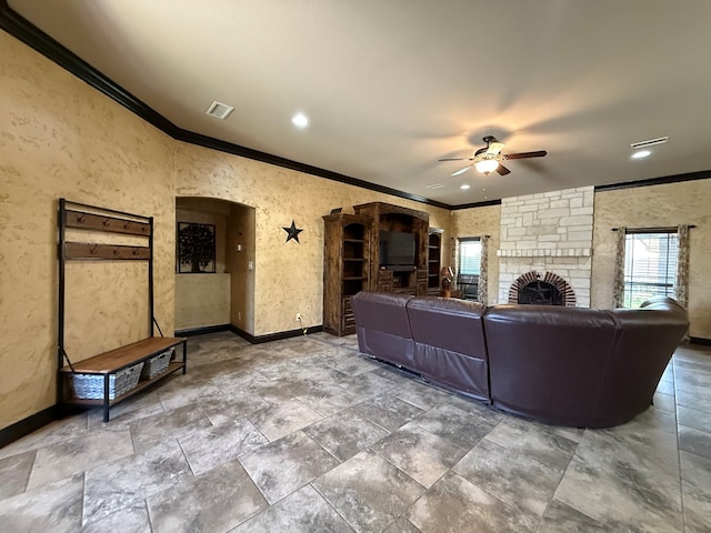 7802 Sienna Dr, Odessa, TX 79765 - living area with ornamental molding, a ceiling fan, stone finish floors, and a fireplace