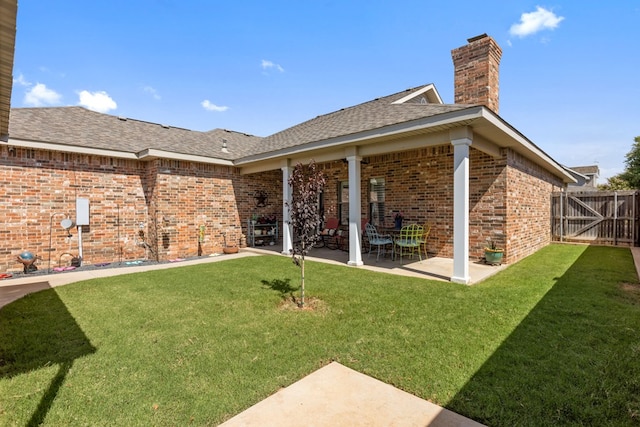 3960 Rabb St, Odessa, TX 79762 - back of house featuring a chimney, a patio, brick siding, and roof with shingles