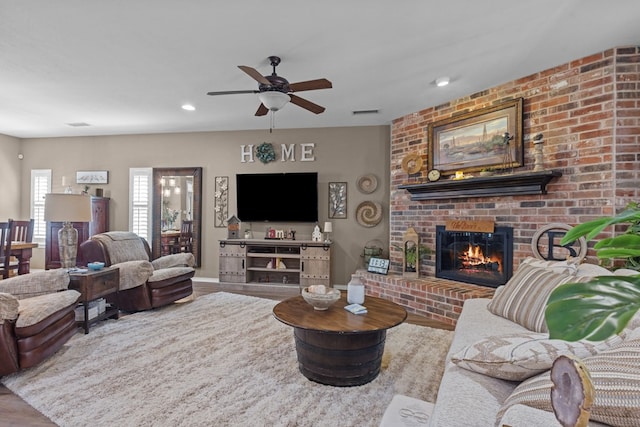 3960 Rabb St, Odessa, TX 79762 - living area with a fireplace, wood finished floors, ceiling fan, and recessed lighting