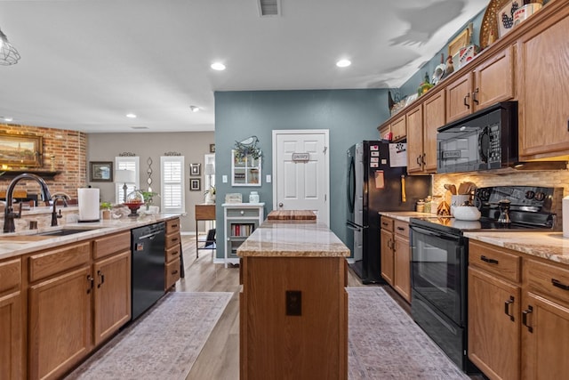 3960 Rabb St, Odessa, TX 79762 - kitchen with black appliances, light countertops, backsplash, a center island, and recessed lighting