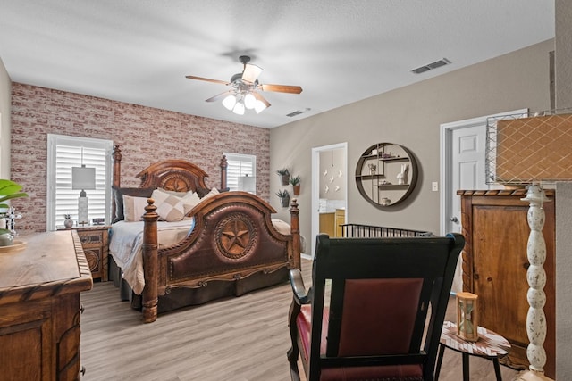 3960 Rabb St, Odessa, TX 79762 - bedroom featuring wallpapered walls, light wood-style floors, ensuite bath, and a ceiling fan