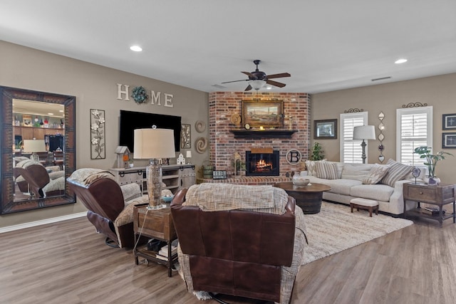 3960 Rabb St, Odessa, TX 79762 - living area featuring wood finished floors, ceiling fan, a brick fireplace, and recessed lighting
