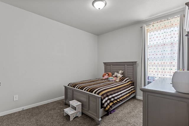 bedroom with light carpet and baseboards